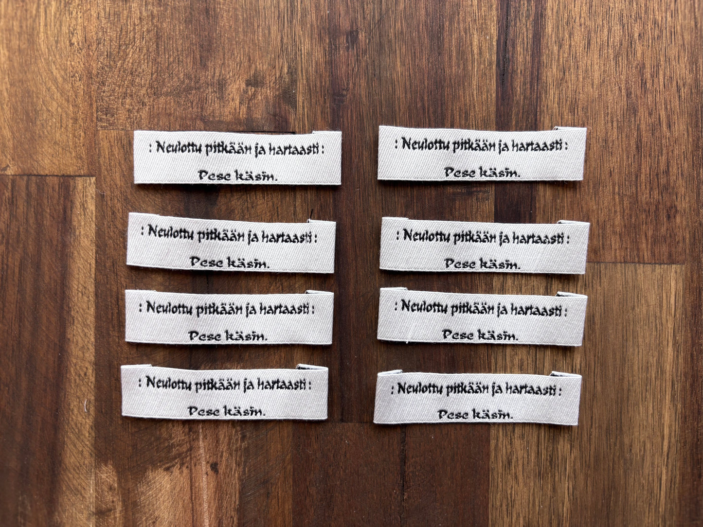 "Neulottu pitkään ja hartaasti. Pese käsin." - Clothing Labels for Knitted Garments - 15 mm height, 60 mm length. 8 pcs. Cotton. Black, white and gray.