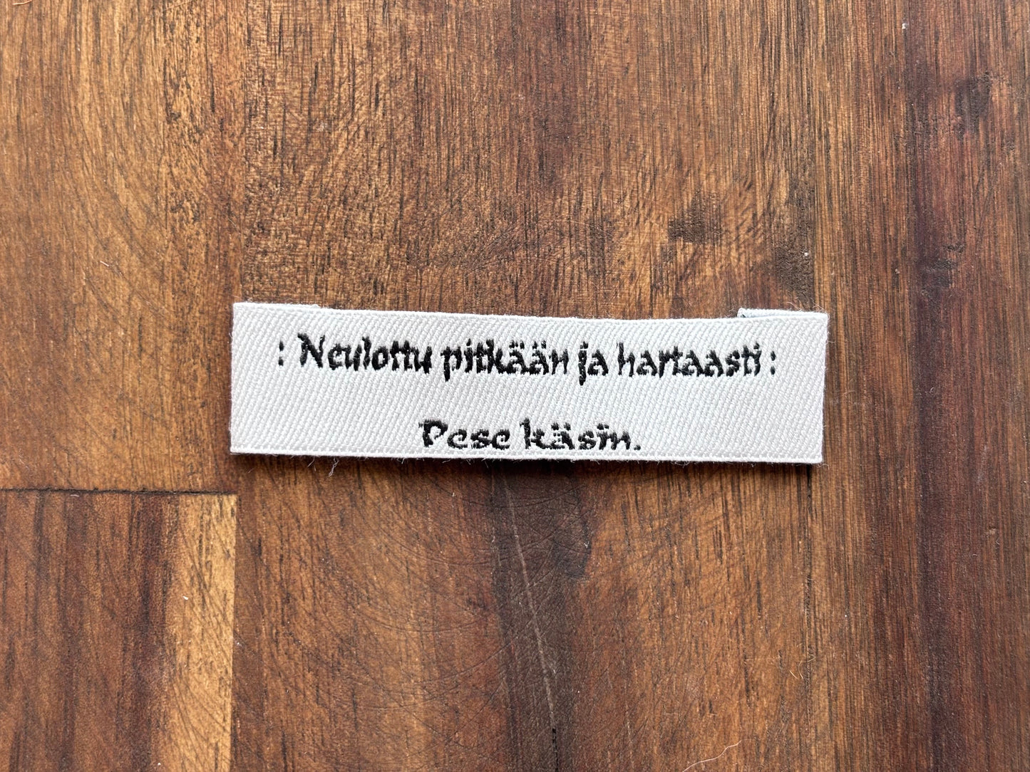 "Neulottu pitkään ja hartaasti. Pese käsin." - Clothing Labels for Knitted Garments - 15 mm height, 60 mm length. 8 pcs. Cotton. Black, white and gray.