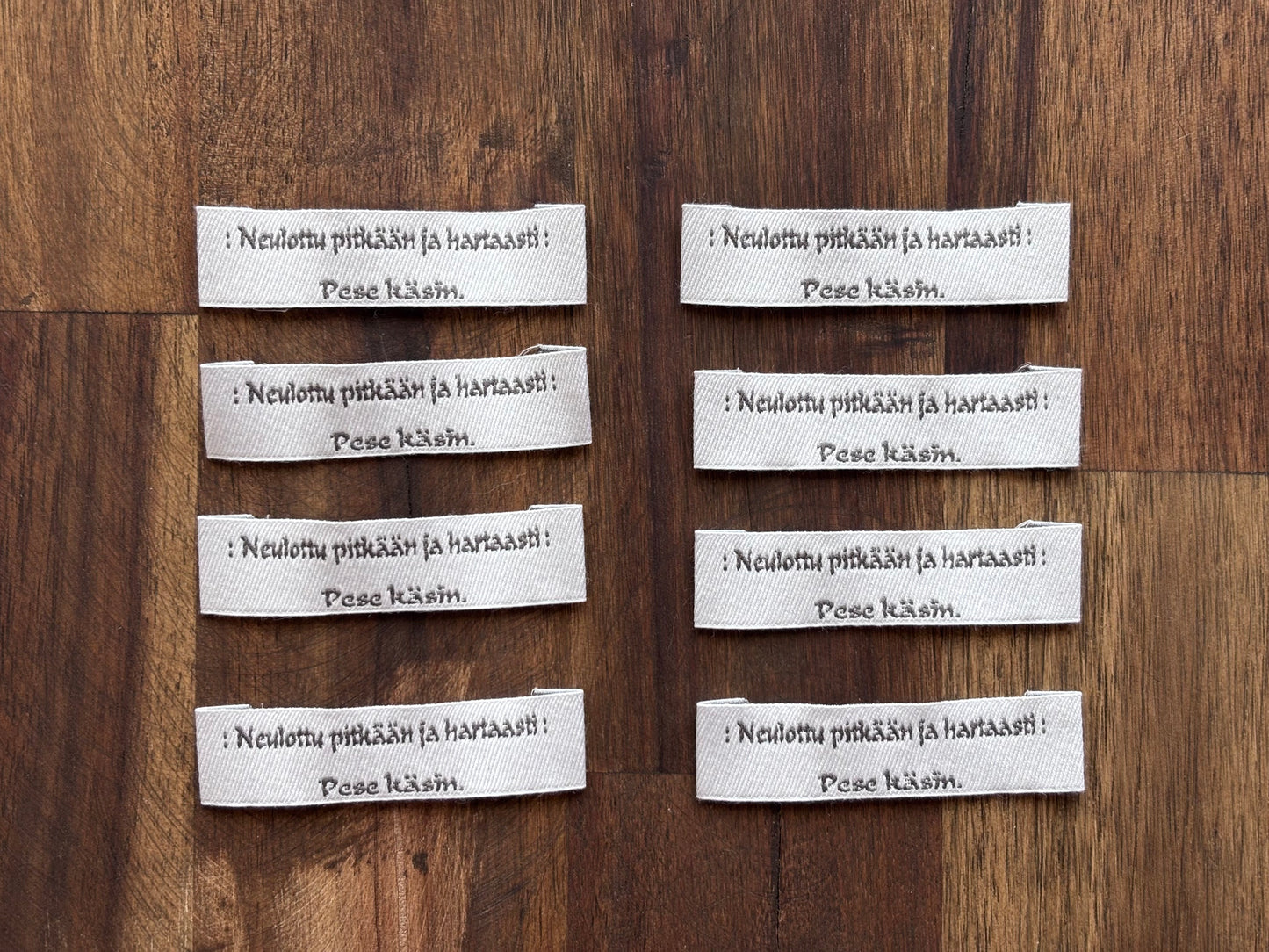 "Neulottu pitkään ja hartaasti. Pese käsin." - Clothing Labels for Knitted Garments - 15 mm height, 60 mm length. 8 pcs. Cotton. Black, white and gray.
