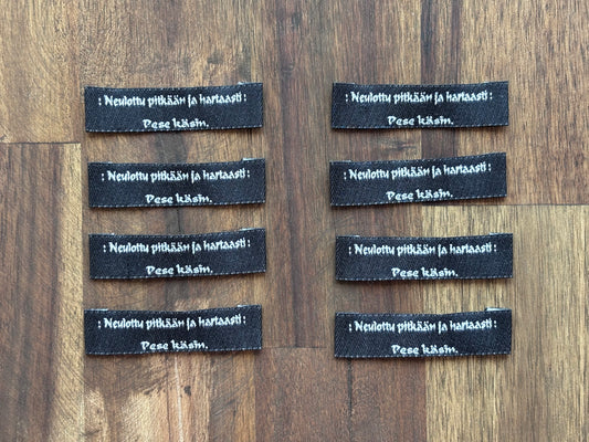 "Neulottu pitkään ja hartaasti. Pese käsin." - Clothing Labels for Knitted Garments - 15 mm height, 60 mm length. 8 pcs. Cotton. Black, white and gray.
