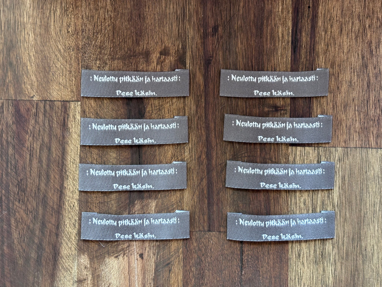 "Neulottu pitkään ja hartaasti. Pese käsin." - Clothing Labels for Knitted Garments - 15 mm height, 60 mm length. 8 pcs. Cotton. Black, white and gray.