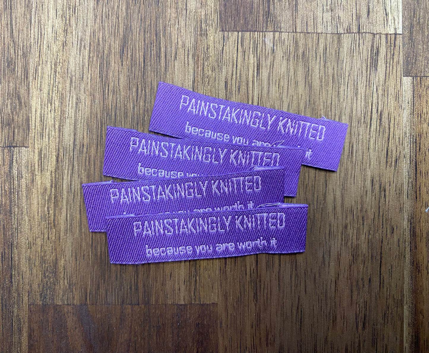 "Painstakingly knitted. Because you are worth it." - Clothing Labels for Knitted Garments - 15 mm height, 60 mm length. Cotton. Pink, purple and beige. (4 pcs / 16 pcs)