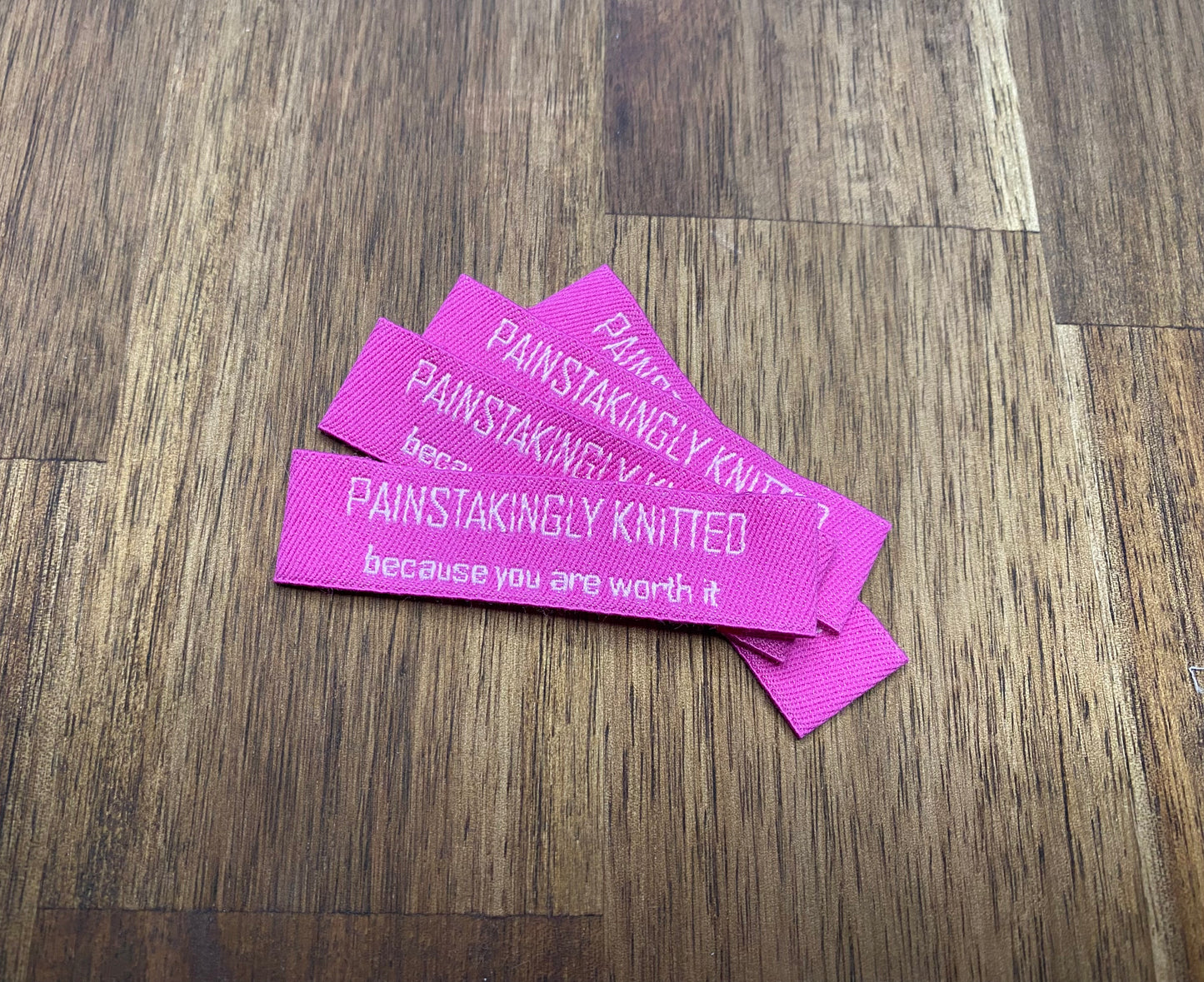 "Painstakingly knitted. Because you are worth it." - Clothing Labels for Knitted Garments - 15 mm height, 60 mm length. Cotton. Pink, purple and beige. (4 pcs / 16 pcs)