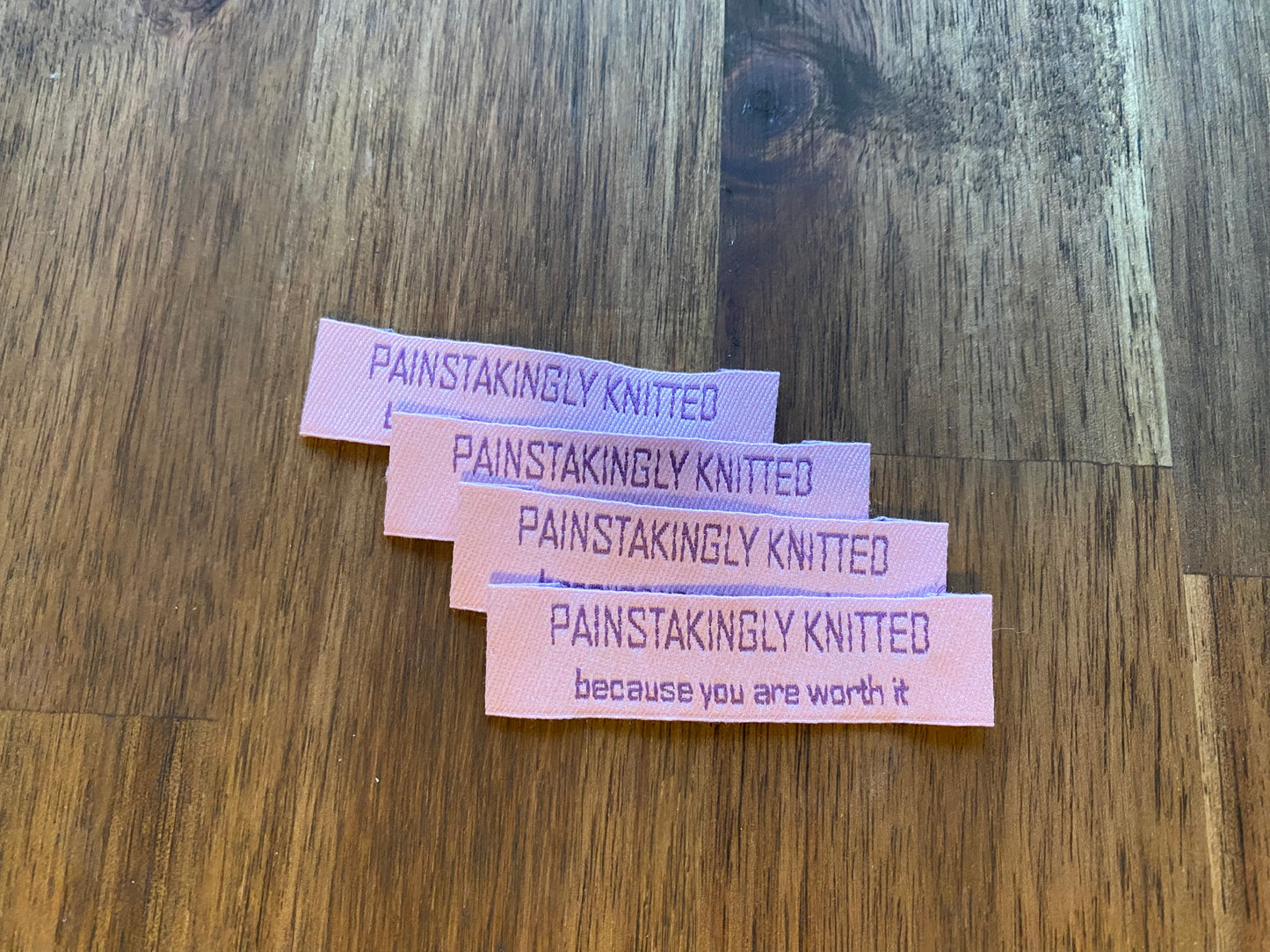 "Painstakingly knitted. Because you are worth it." - Clothing Labels for Knitted Garments - 15 mm height, 60 mm length. Cotton. Pink, purple and beige. (4 pcs / 16 pcs)