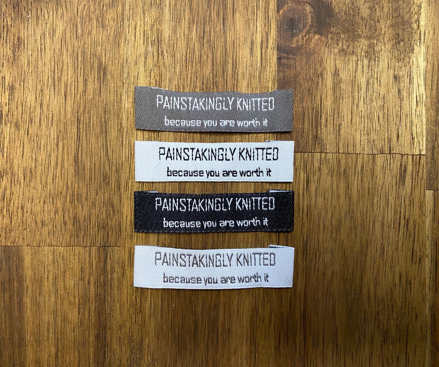 "Painstakingly knitted. Because you are worth it." - Clothing Labels for Knitted Garments - 15 mm height, 60 mm length. 4 pcs. Cotton. Black, white and gray.