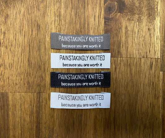 "Painstakingly knitted. Because you are worth it." - Clothing Labels for Knitted Garments - 15 mm height, 60 mm length. 4 pcs. Cotton. Black, white and gray.