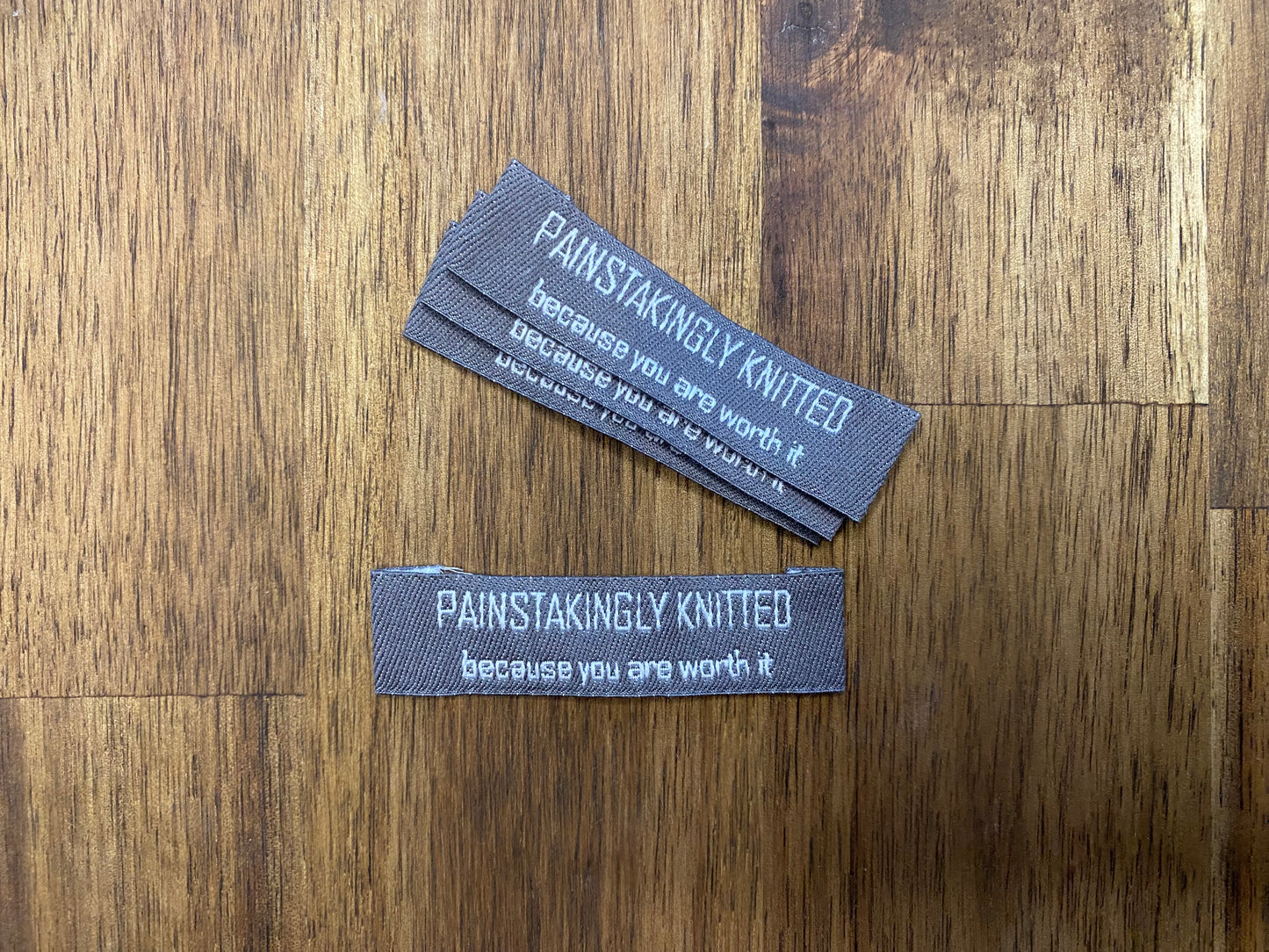 "Painstakingly knitted. Because you are worth it." - Clothing Labels for Knitted Garments - 15 mm height, 60 mm length. 4 pcs. Cotton. Black, white and gray.