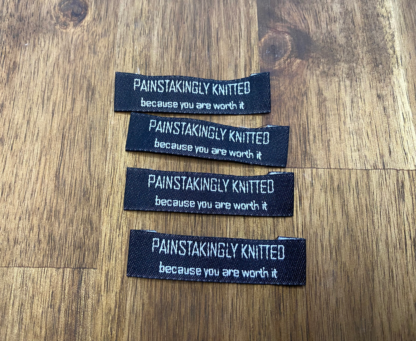 "Painstakingly knitted. Because you are worth it." - Clothing Labels for Knitted Garments - 15 mm height, 60 mm length. 4 pcs. Cotton. Black, white and gray.