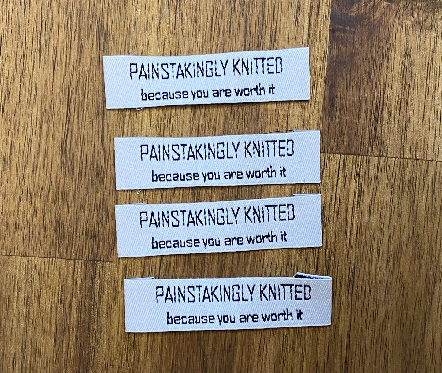 "Painstakingly knitted. Because you are worth it." - Clothing Labels for Knitted Garments - 15 mm height, 60 mm length. 4 pcs. Cotton. Black, white and gray.