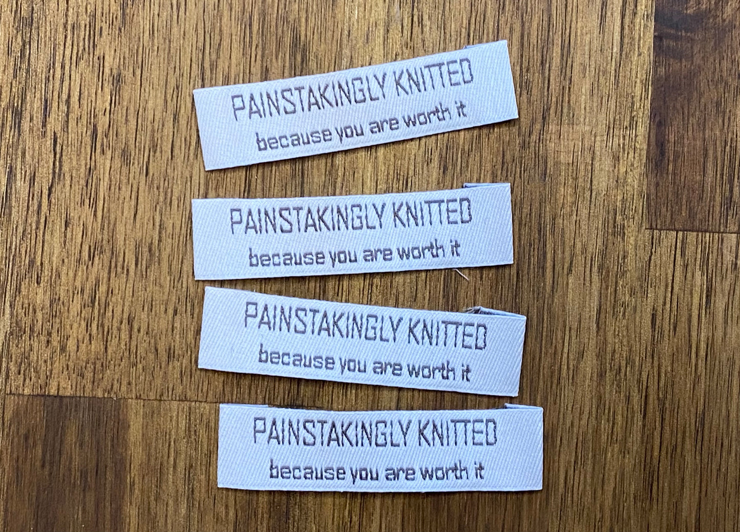 "Painstakingly knitted. Because you are worth it." - Clothing Labels for Knitted Garments - 15 mm height, 60 mm length. 4 pcs. Cotton. Black, white and gray.