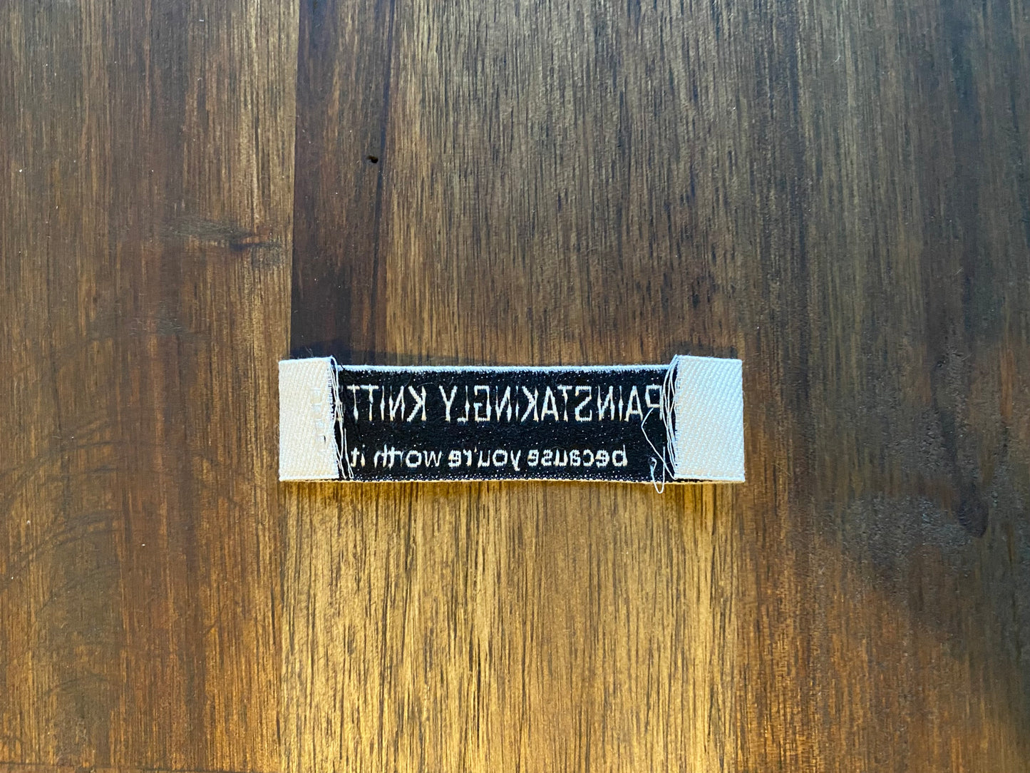 "Painstakingly knitted. Because you are worth it." - Clothing Labels for Knitted Garments - 15 mm height, 60 mm length. 8 pcs. Cotton.